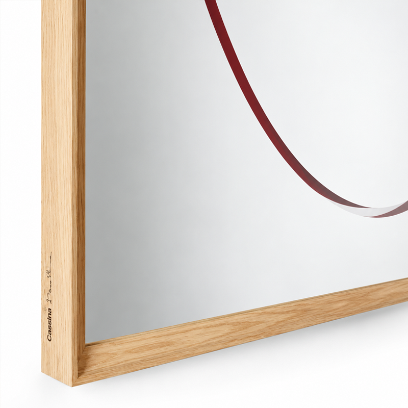 Gros plan sur le cercle rouge et l'assemblage du cadre en frêne naturel du miroir Eternal Sun Cassina