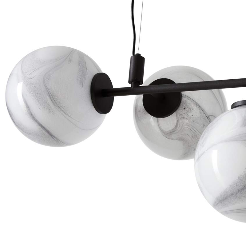 Gros plan sur les globes en verre soufflé marbré blanc et la structure noire de la suspension Starburst Cassina